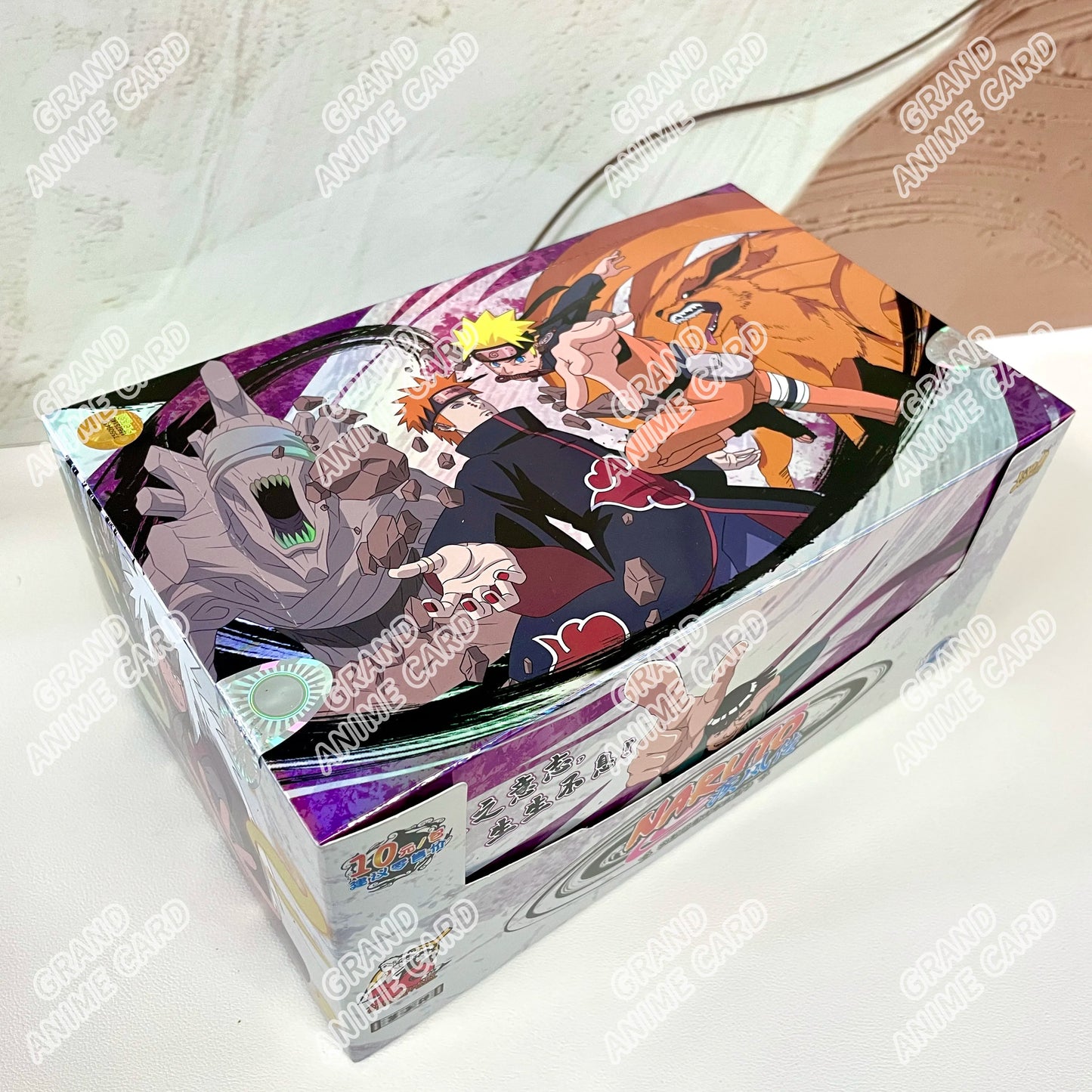 Scatola di carte Naruto KAYOU della collezione Booster Box T2W9 e T4W8, con illustrazioni di personaggi Naruto e altri protagonisti.